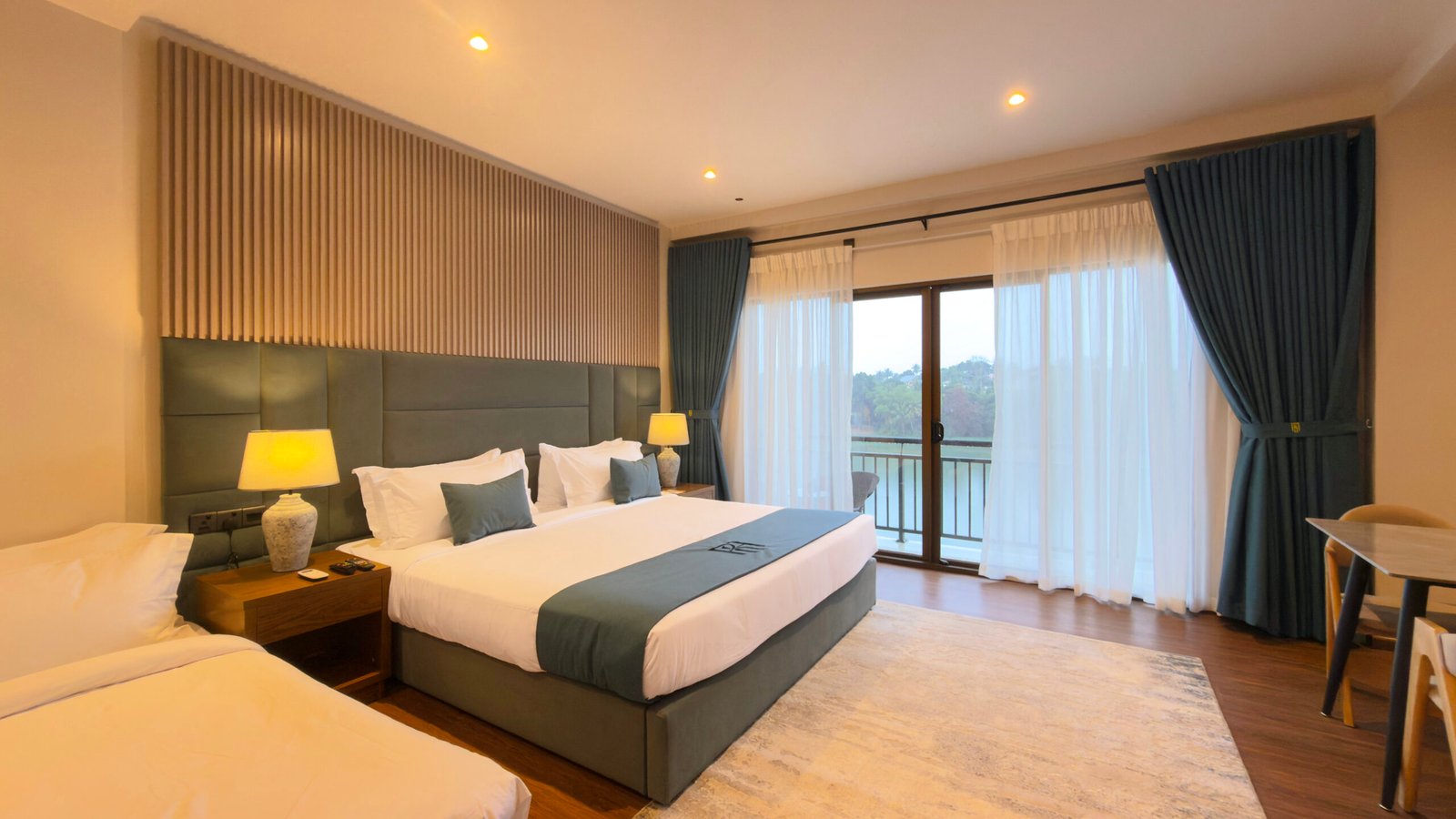 Mahaweli Suite bedroom with river-facing balcony